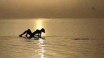 Monika Fox swims in sea at sunset video